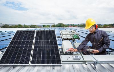 Solar technician inspecting panels